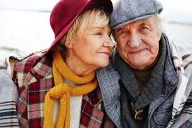 An older couple is posing for a picture.