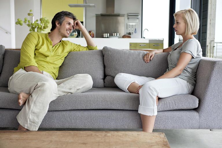 A man and woman sitting on top of a couch.